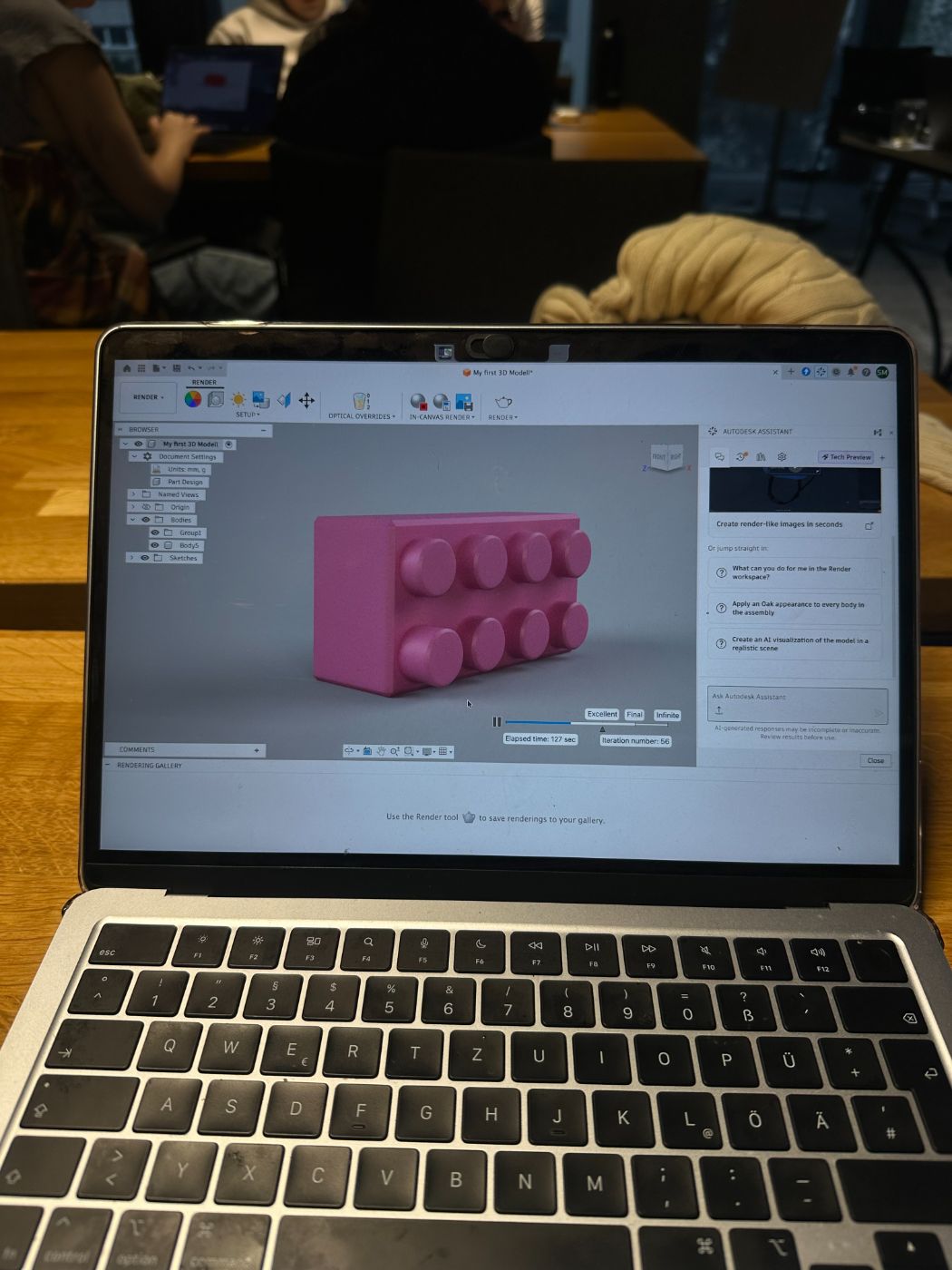 Laptop showing a CAD model of a building brick